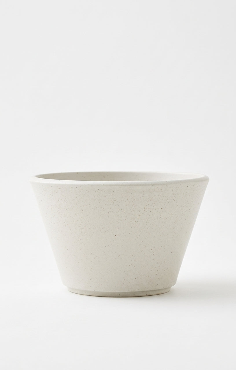 A minimalist, tapered ceramic planter or bowl in a light warm gray speckled finish, photographed against a seamless white background.