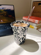 coffee in a black splash marble cup
