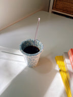 blue splashed marble cup with black coffee