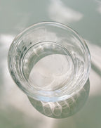 Clear glass bowl on a reflective surface