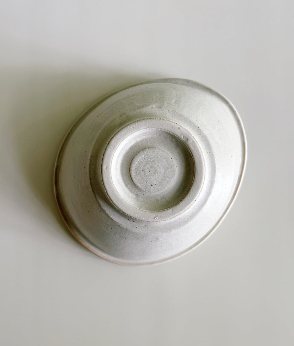 White ceramic bowl on a light gray background