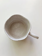 Speckled ceramic mug on a white background